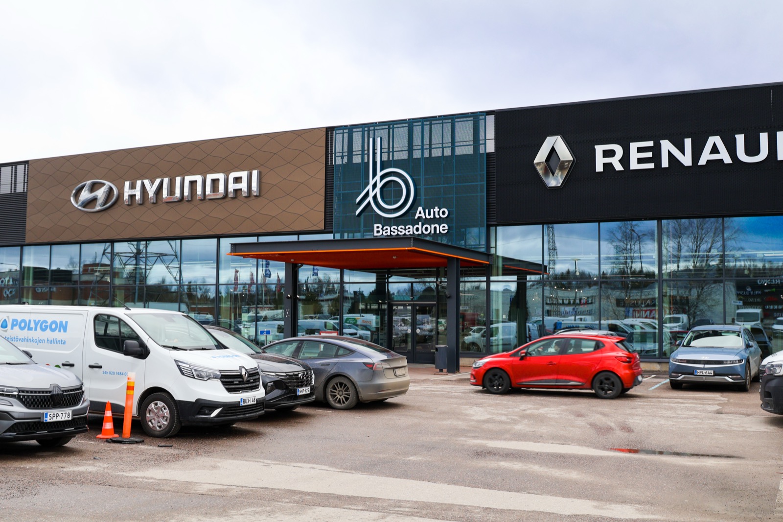 Exterior de un concesionario con coches nuevos aparcados delante