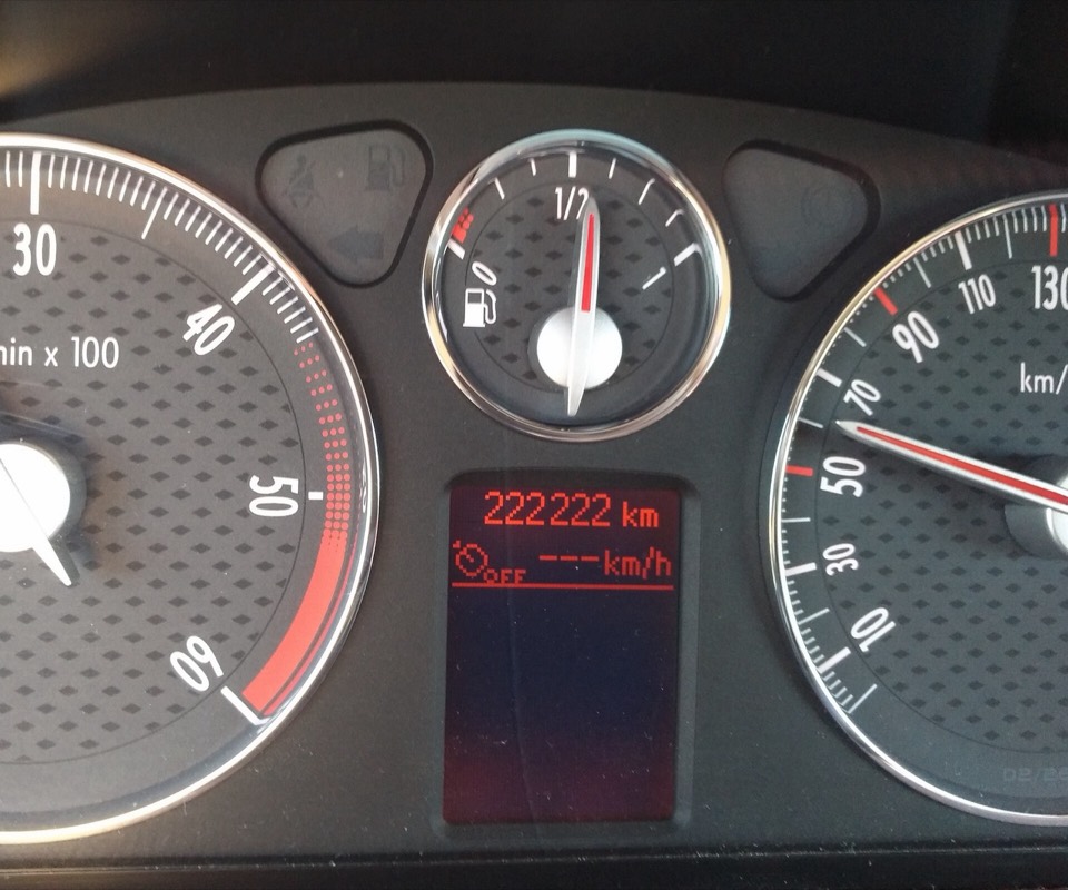 Cuadro de instrumentos de un coche mostrando 222.222 kilómetros en el odómetro