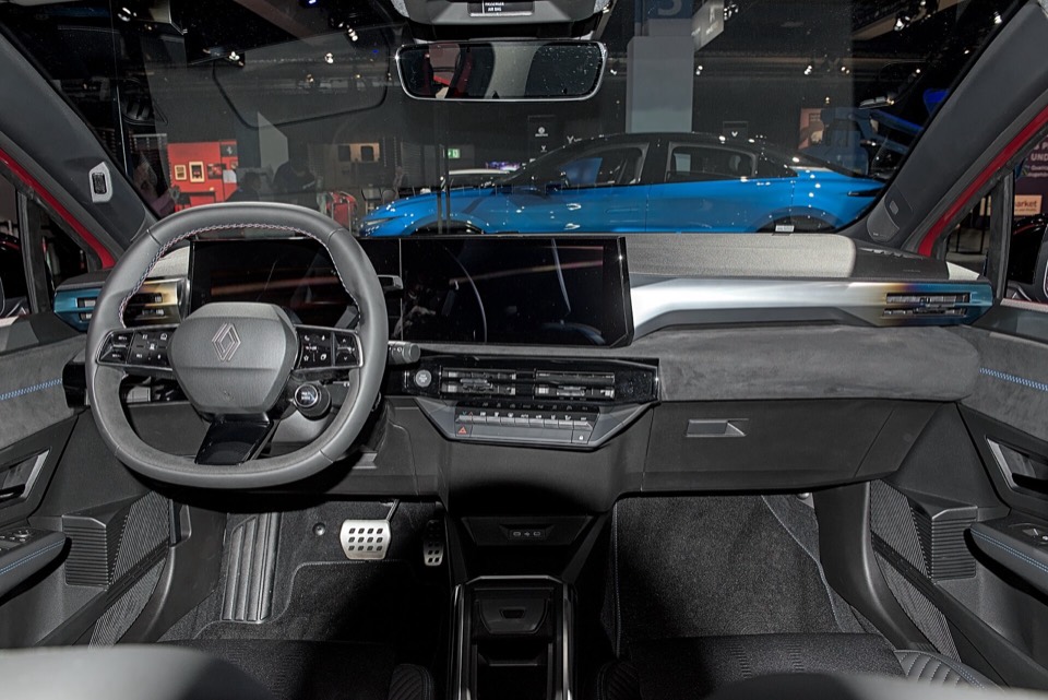 Puesto de conducción de un Renault Clio VI con volante de dos radios, cuadro digital y pantalla central vertical