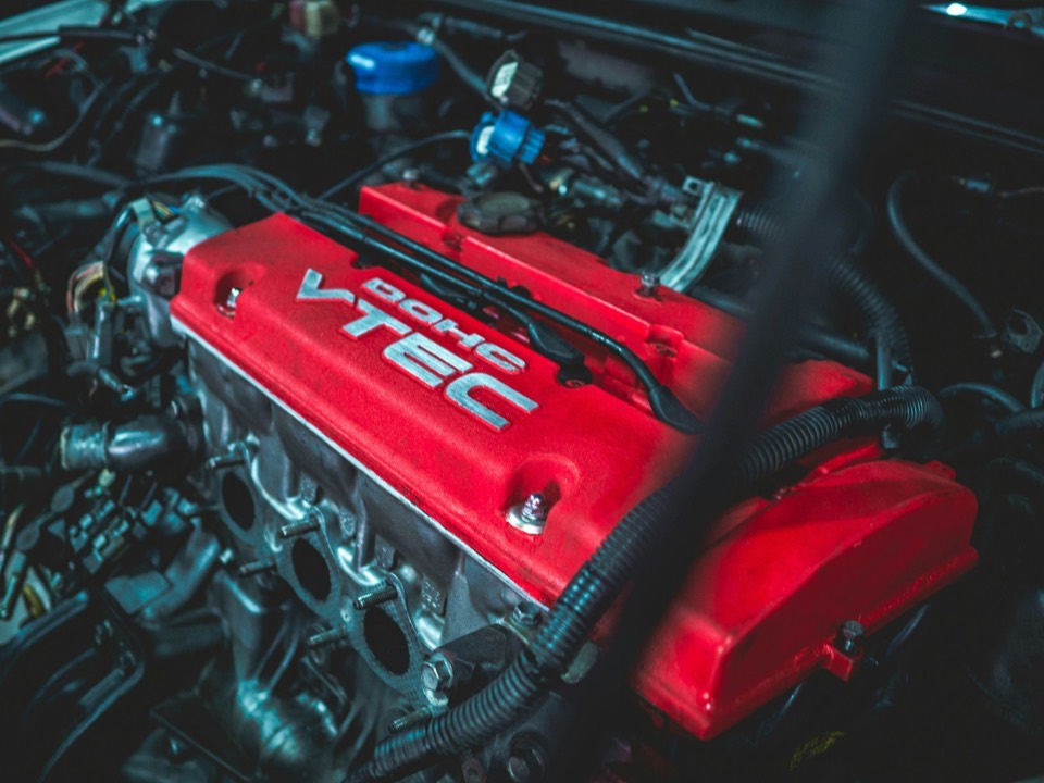 Tapa de un motor de gasolina con la culata en rojo